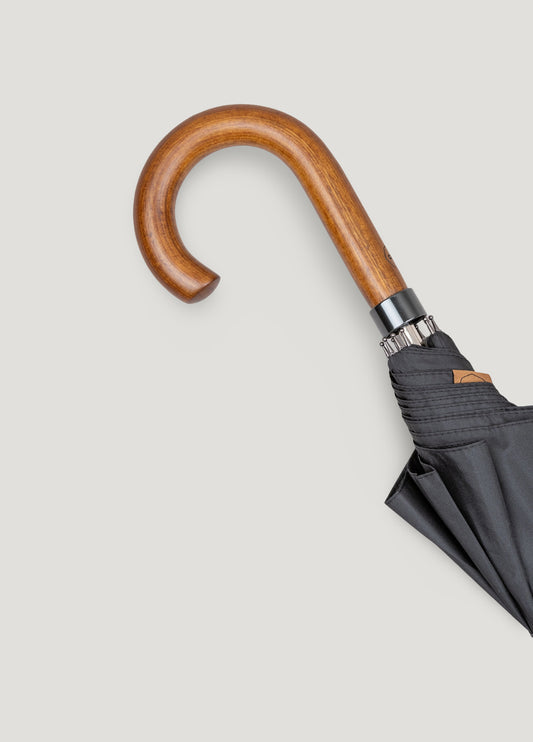Black umbrella with wooden handle.